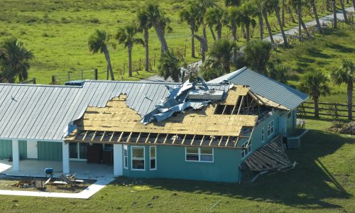 Hurricane Ian destroyed house roof in Florida residential area. Natural disaster and its consequences.